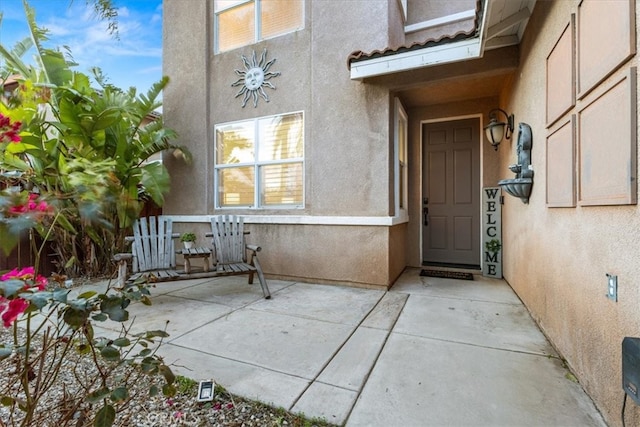 property entrance with stucco siding