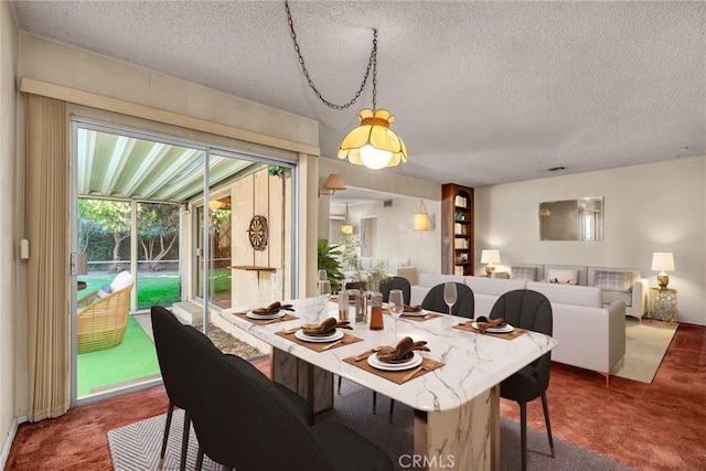 dining space with carpet flooring and a textured ceiling