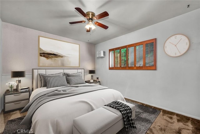 carpeted bedroom featuring baseboards and a ceiling fan