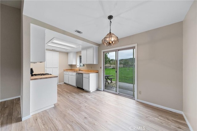 kitchen featuring light wood-type flooring, visible vents, white cabinetry, baseboards, and dishwasher