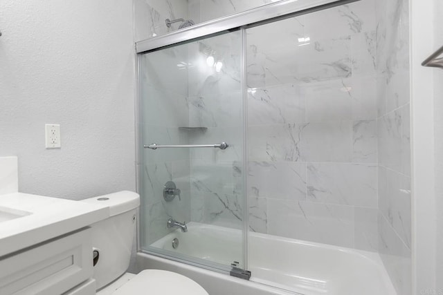 full bath with shower / bath combination with glass door, toilet, a textured wall, and vanity