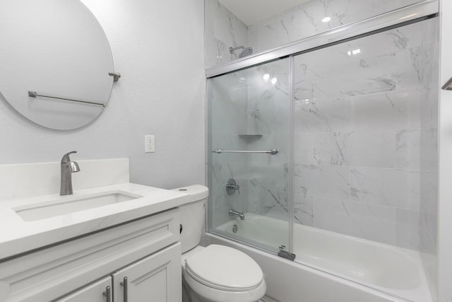 full bath with toilet, enclosed tub / shower combo, and vanity