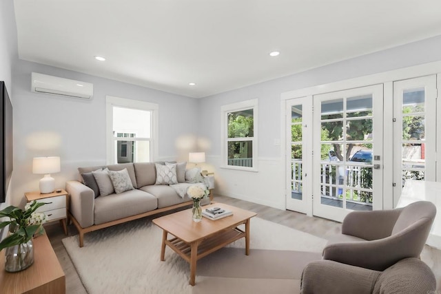 living room featuring light wood-style floors, plenty of natural light, an AC wall unit, and recessed lighting