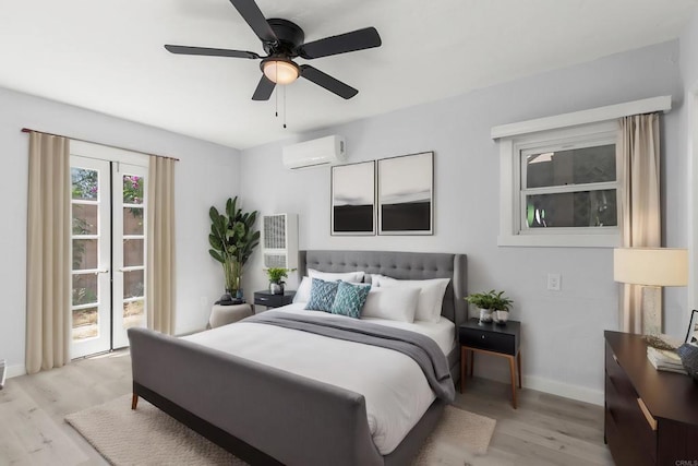 bedroom with baseboards, a wall mounted air conditioner, light wood-style flooring, and a ceiling fan