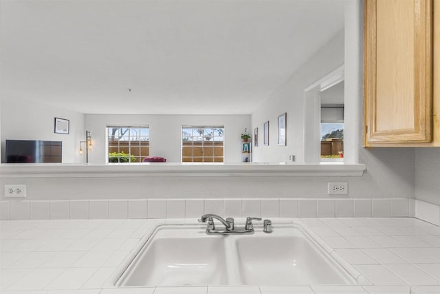 room details with tile countertops and a sink