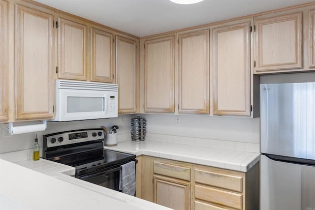 kitchen with light brown cabinets and stainless steel appliances