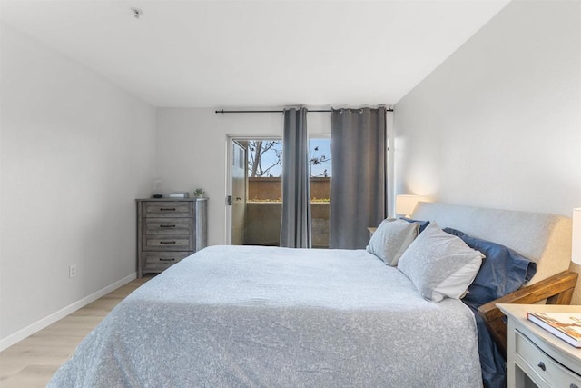 bedroom with baseboards, access to outside, and light wood finished floors