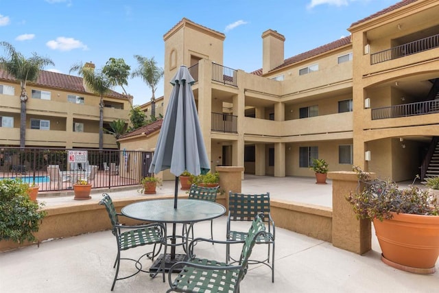 view of patio / terrace featuring outdoor dining area and fence