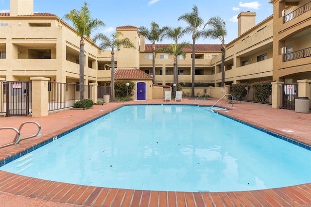 pool featuring a patio area and fence