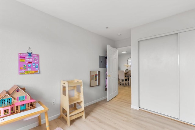 bedroom with a closet, baseboards, and wood finished floors