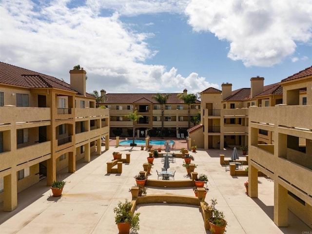 pool featuring a residential view and a patio