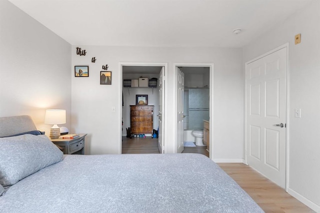 bedroom featuring wood finished floors and baseboards