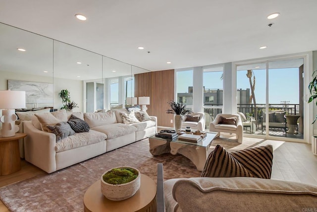 living room featuring wood finished floors, recessed lighting, and expansive windows