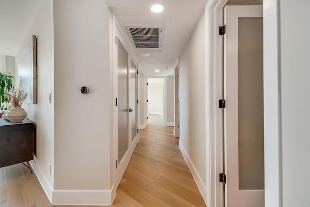 hall featuring recessed lighting, baseboards, visible vents, and light wood-type flooring