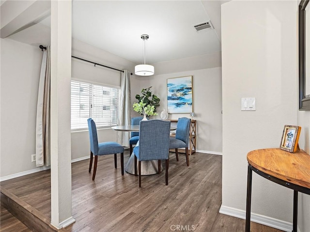 dining space featuring visible vents, baseboards, and wood finished floors