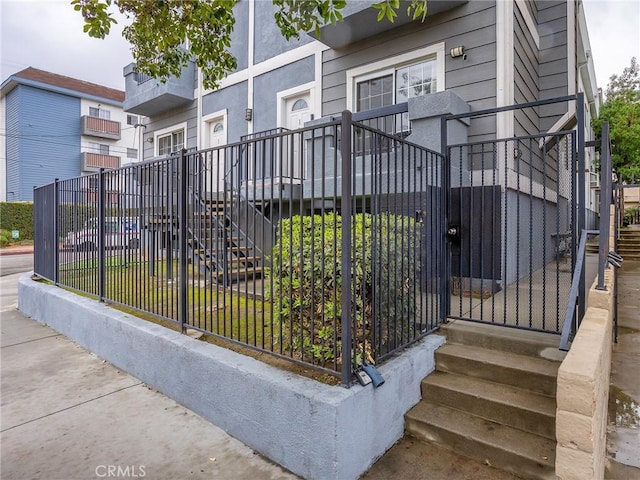 exterior space featuring stairs and fence