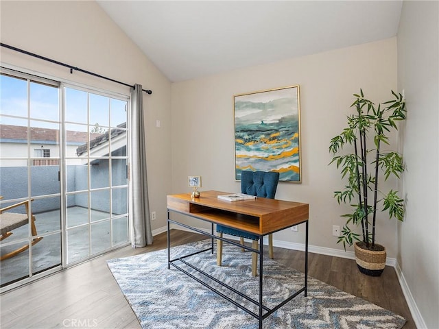 office featuring wood finished floors, baseboards, and vaulted ceiling