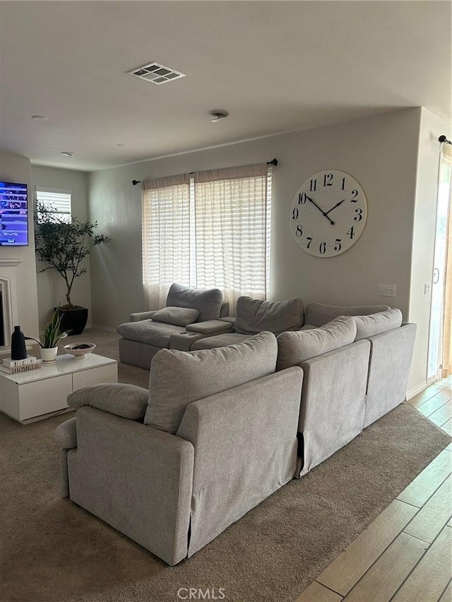 living room with wood finished floors and visible vents