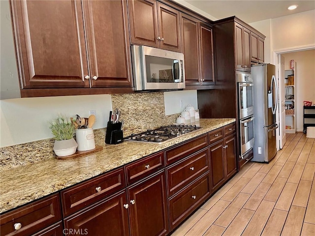 3204 E Denali Dr, Ontario, CA 91762 - kitchen with backsplash, recessed lighting, appliances with stainless steel finishes, light wood finished floors, and light stone countertops