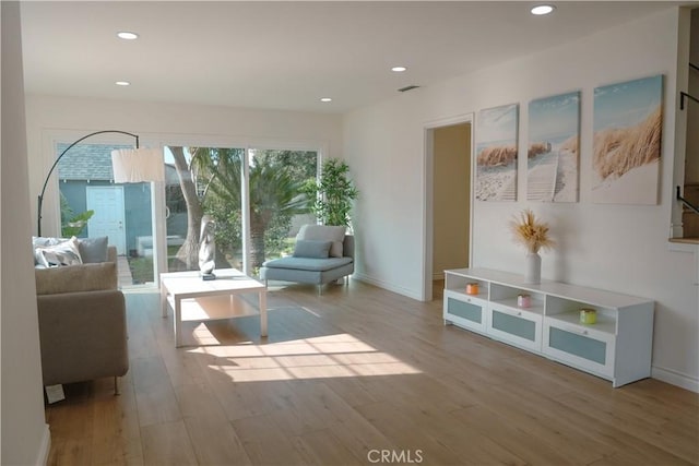 living area with visible vents, recessed lighting, baseboards, and wood finished floors