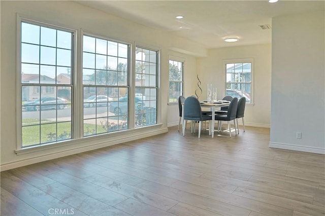 dining room with recessed lighting, light wood-type flooring, baseboards, and visible vents