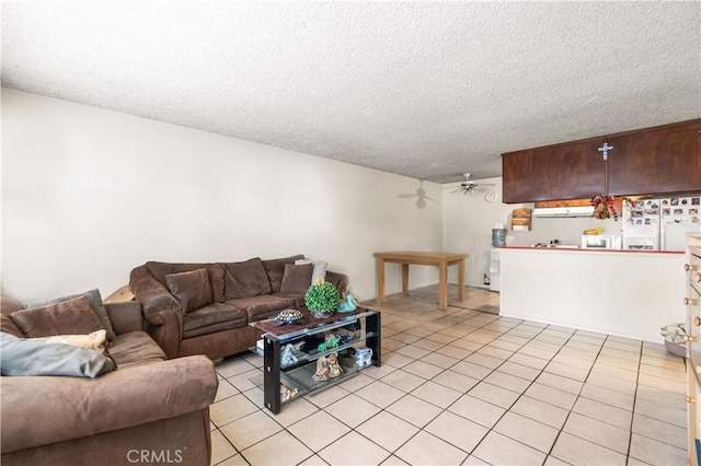 living room featuring light tile patterned floors, a textured ceiling, and ceiling fan