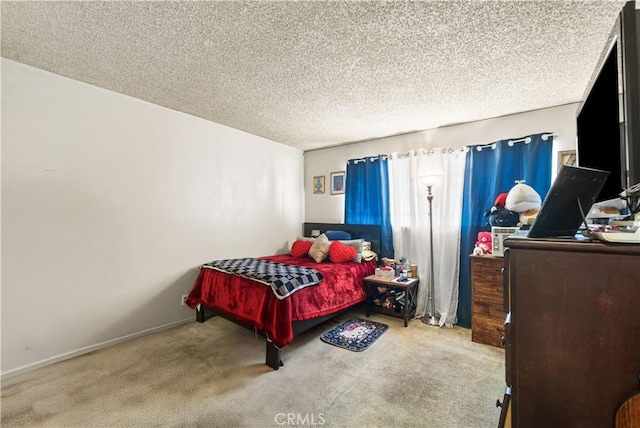 carpeted bedroom with baseboards and a textured ceiling