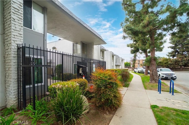 view of property exterior with stucco siding and fence