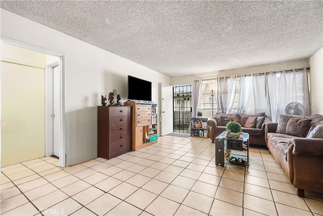 living room featuring a textured ceiling and light tile patterned flooring