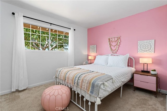 bedroom featuring baseboards and carpet