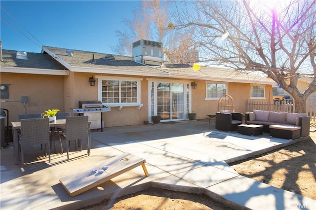 56838 Bonanza Dr, Yucca Valley, CA 92284 - back of property with stucco siding, a patio, an outdoor living space, and a shingled roof