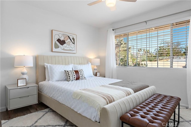 bedroom featuring baseboards, a ceiling fan, and wood finished floors