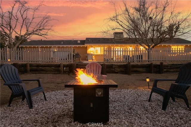 view of patio featuring a wooden deck and a fire pit