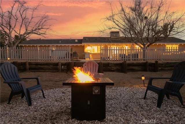 56838 Bonanza Dr, Yucca Valley, CA 92284 - patio terrace at dusk featuring a fire pit and a deck