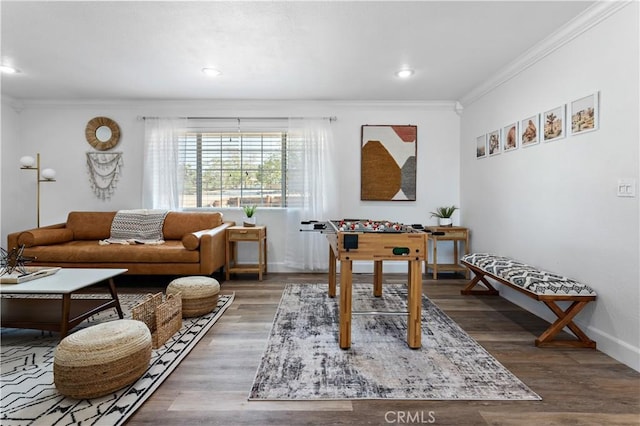 interior space featuring recessed lighting, baseboards, wood finished floors, and crown molding