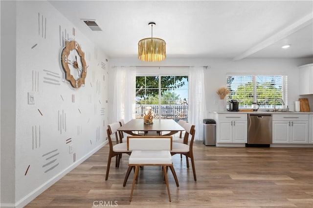56838 Bonanza Dr, Yucca Valley, CA 92284 - dining area with healthy amount of natural light, light wood-style floors, recessed lighting, baseboards, and beamed ceiling