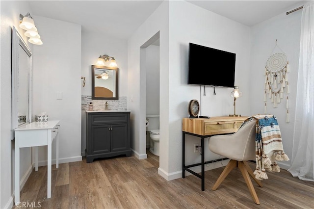 home office featuring baseboards and wood finished floors