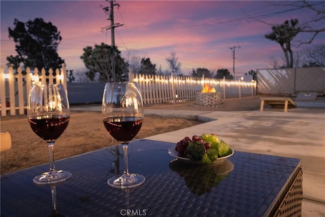 exterior space featuring an outdoor fire pit and fence