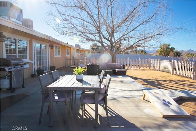 view of patio / terrace with an outdoor hangout area, a grill, outdoor dining space, and fence