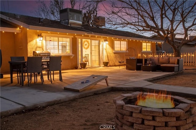 56838 Bonanza Dr, Yucca Valley, CA 92284 - back of property with an outdoor living space with a fire pit, a patio area, stucco siding, and outdoor dining space