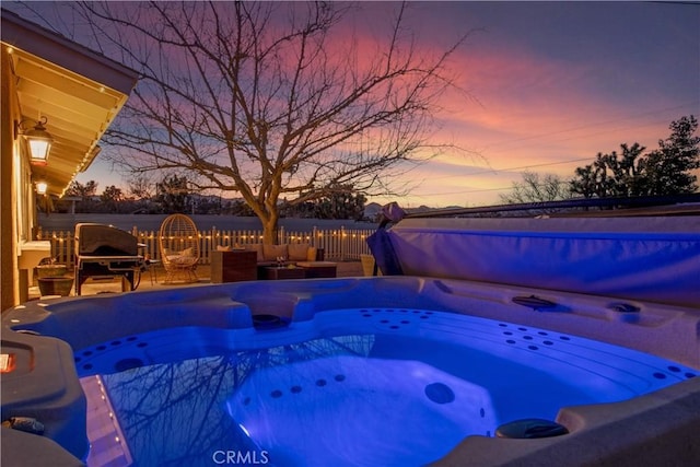 view of pool featuring a hot tub and fence