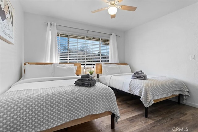 bedroom featuring a ceiling fan and wood finished floors