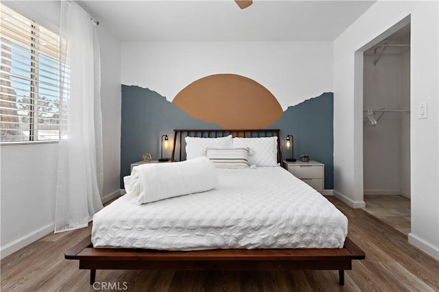 bedroom featuring baseboards and wood finished floors