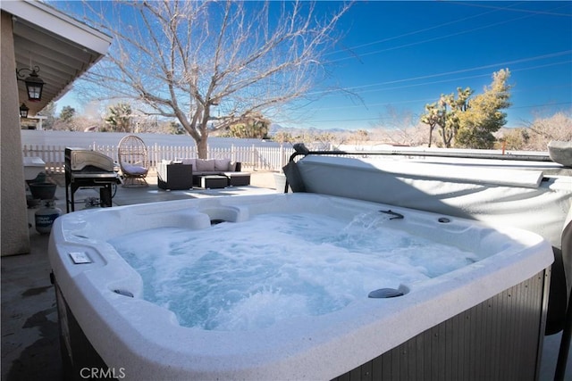 exterior details with a jacuzzi and fence