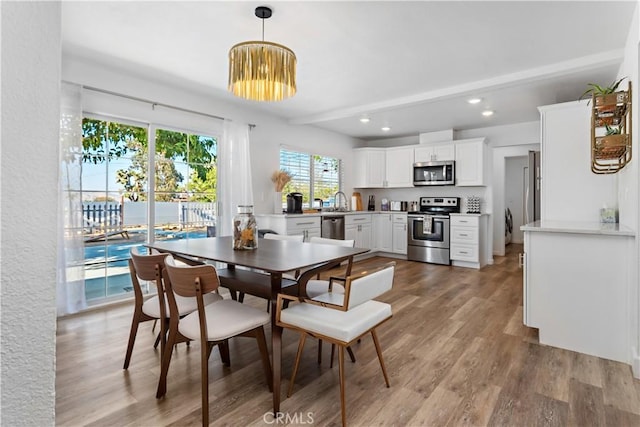 dining room featuring recessed lighting and light wood finished floors