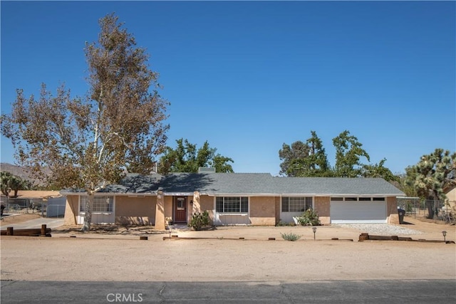 56838 Bonanza Dr, Yucca Valley, CA 92284 - ranch-style house with an attached garage and driveway
