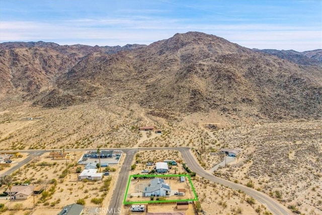 7068 Eucalyptus Ave Unit 29, Palms, CA 92277 - aerial view of sparsely populated area featuring a mountain backdrop and property parcel outlined