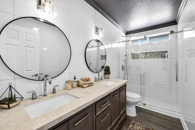 full bath featuring tile walls, ornamental molding, and a sink