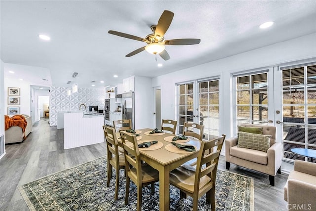 7068 Eucalyptus Ave Unit 29, Palms, CA 92277 - dining space with french doors, ceiling fan, wood finished floors, and recessed lighting