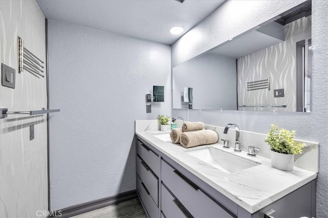 7068 Eucalyptus Ave Unit 29, Palms, CA 92277 - bathroom with a textured wall, vanity, wood finished floors, and baseboards